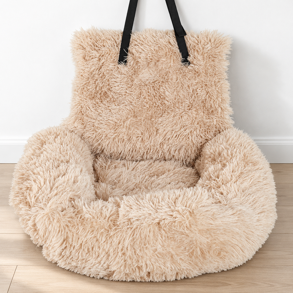 Empty beige shaggy pet car bed on a pale wood floor