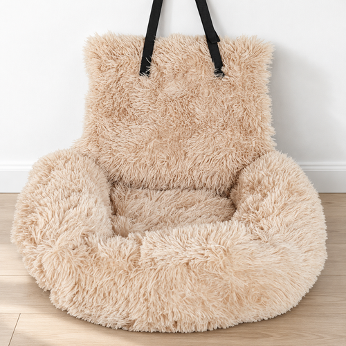 Empty beige shaggy pet car bed on a pale wood floor