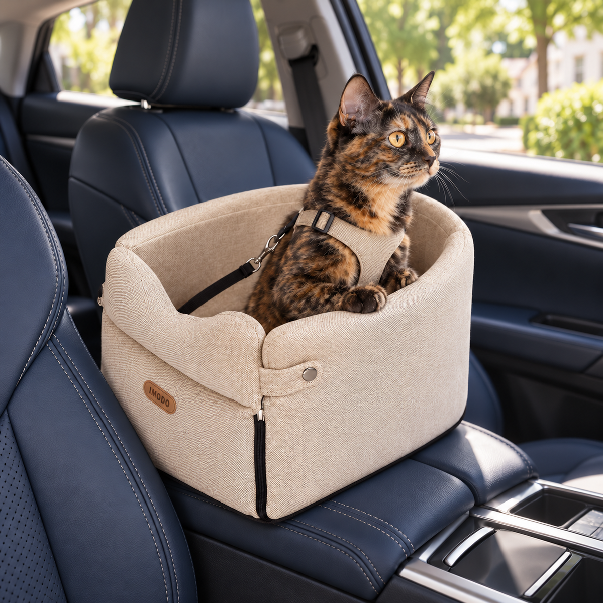 Beige canvas console pet seat with a tortoiseshell cat in a parked car