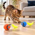Bengal cat chasing blue Speedy Tail ball beside orange companion