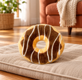 Single chocolate-brown plush donut dog toy on a linen mat in a living room