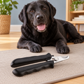 Tweezerman dog nail clipper beside a calm black Labrador