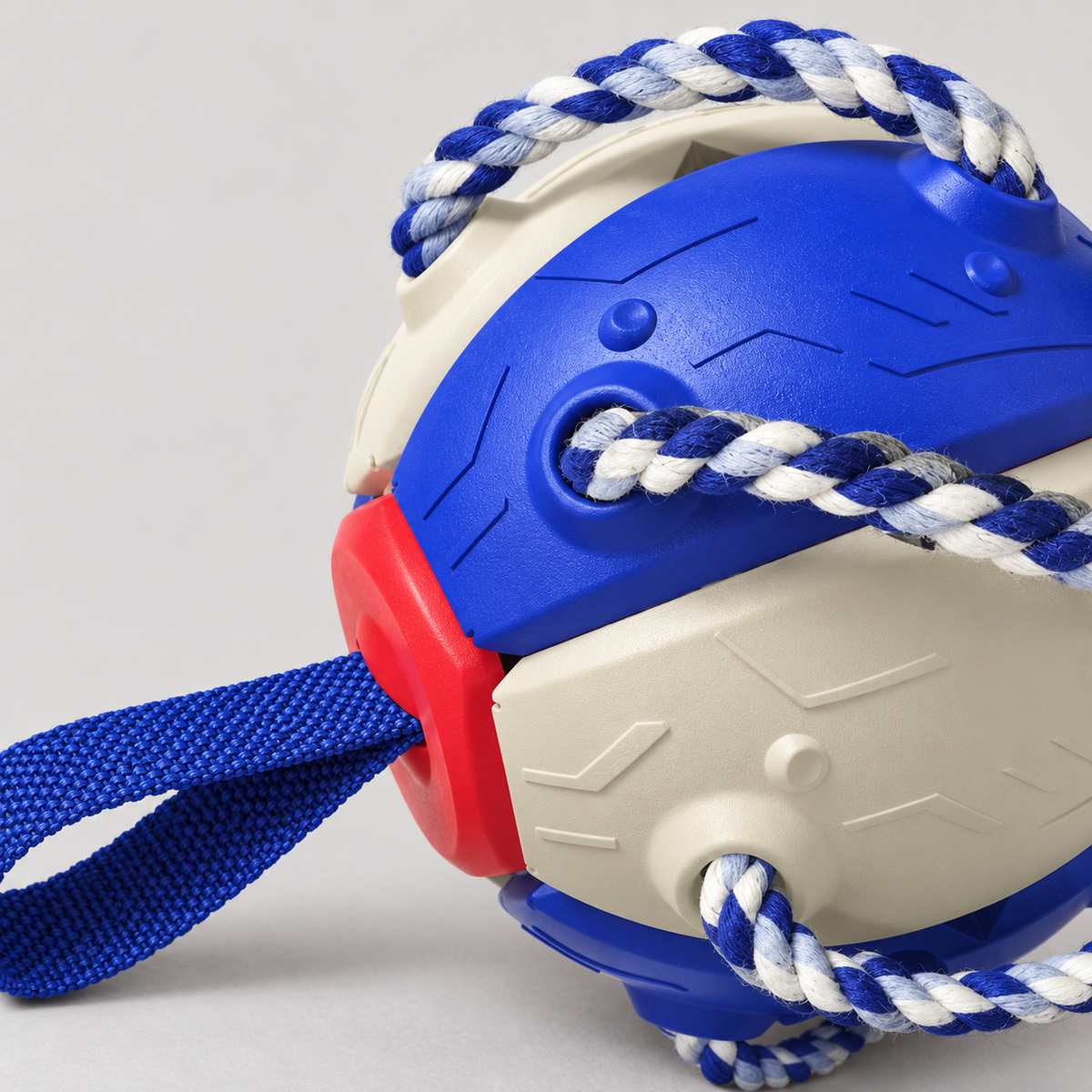 Close-up of the American Blue dog ball's moulded body, braided rope and fabric handle