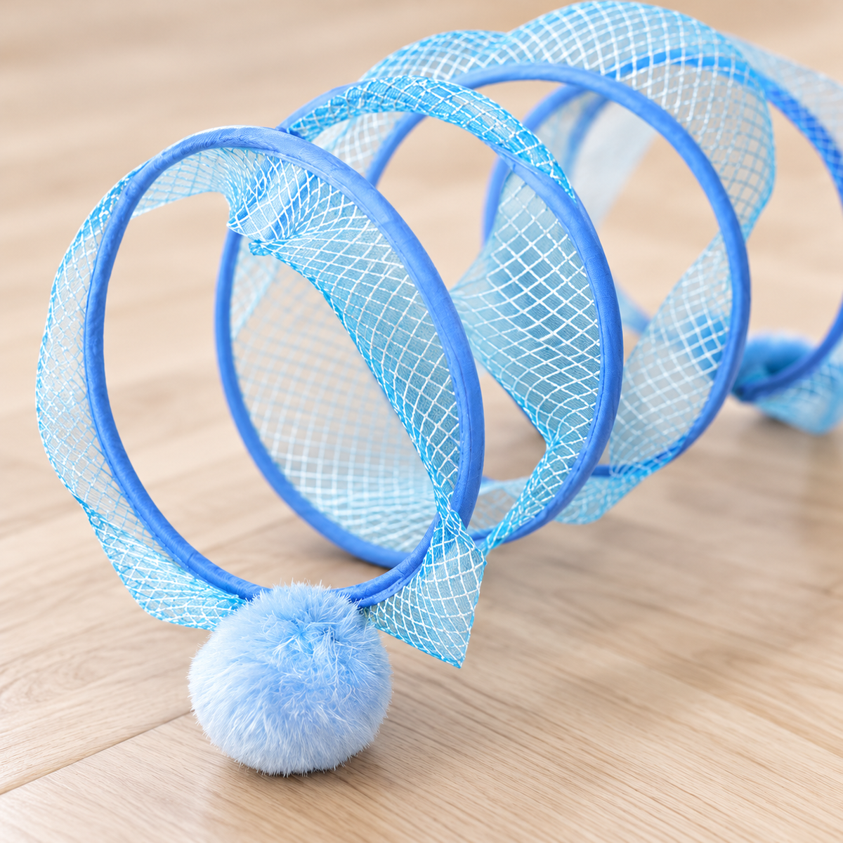 Close-up of mesh frame and attached pom toy